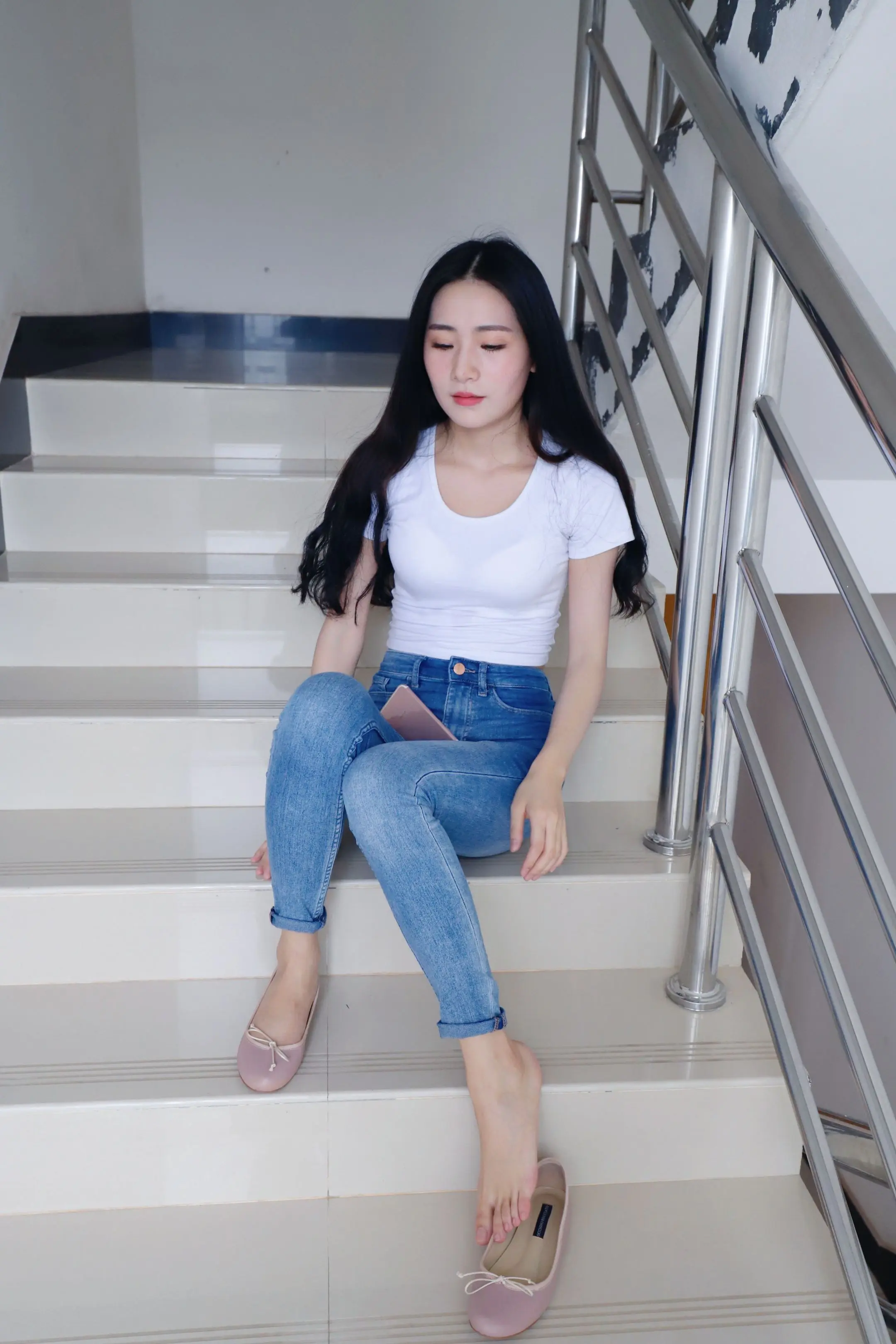 楼梯的转角藏着时光的秘密，光影在台阶上跳跃出无声的旋律。白色的T恤是纯...