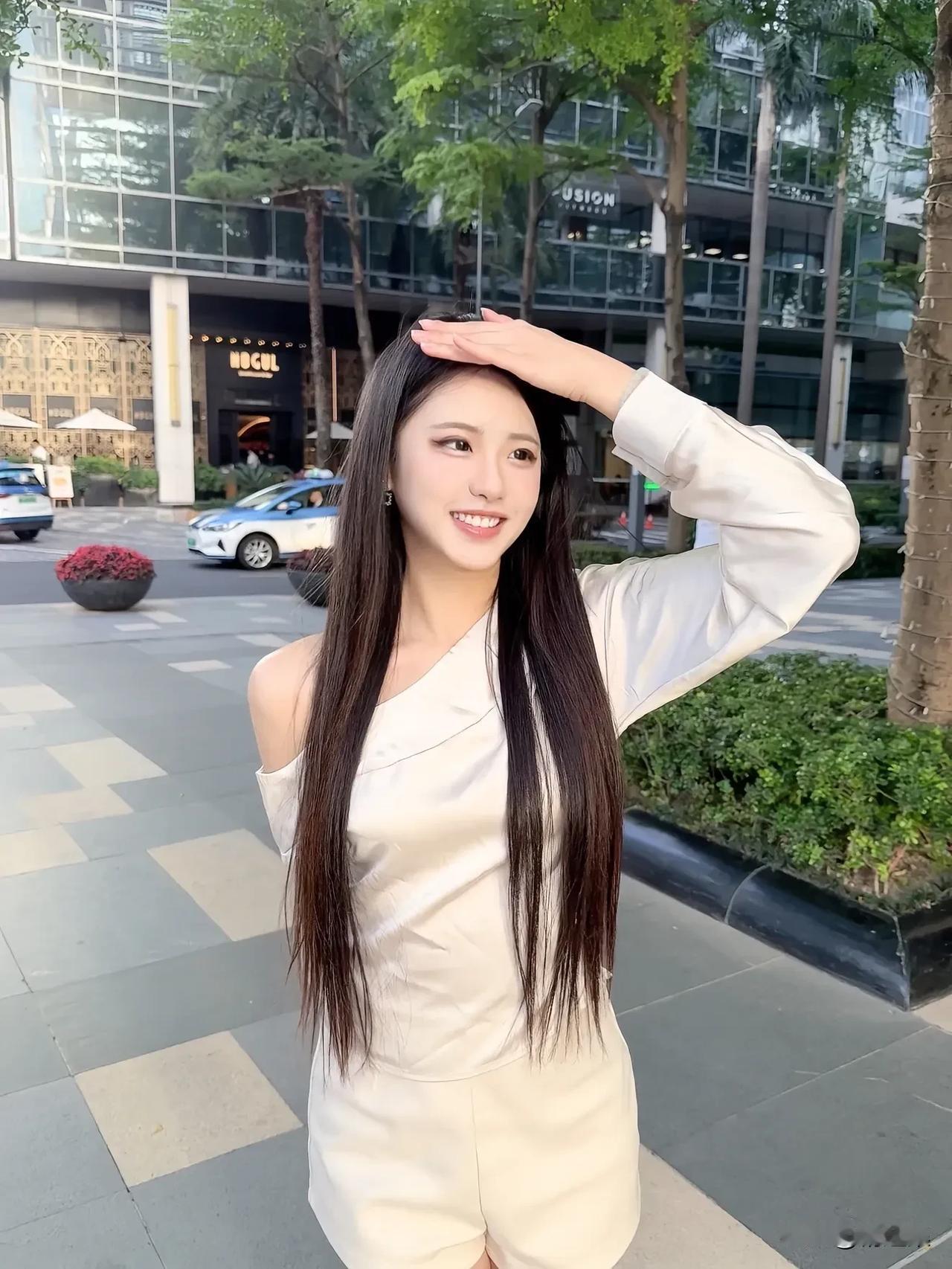 阳光明媚的一天，元气满满的少女在城市街头微笑。