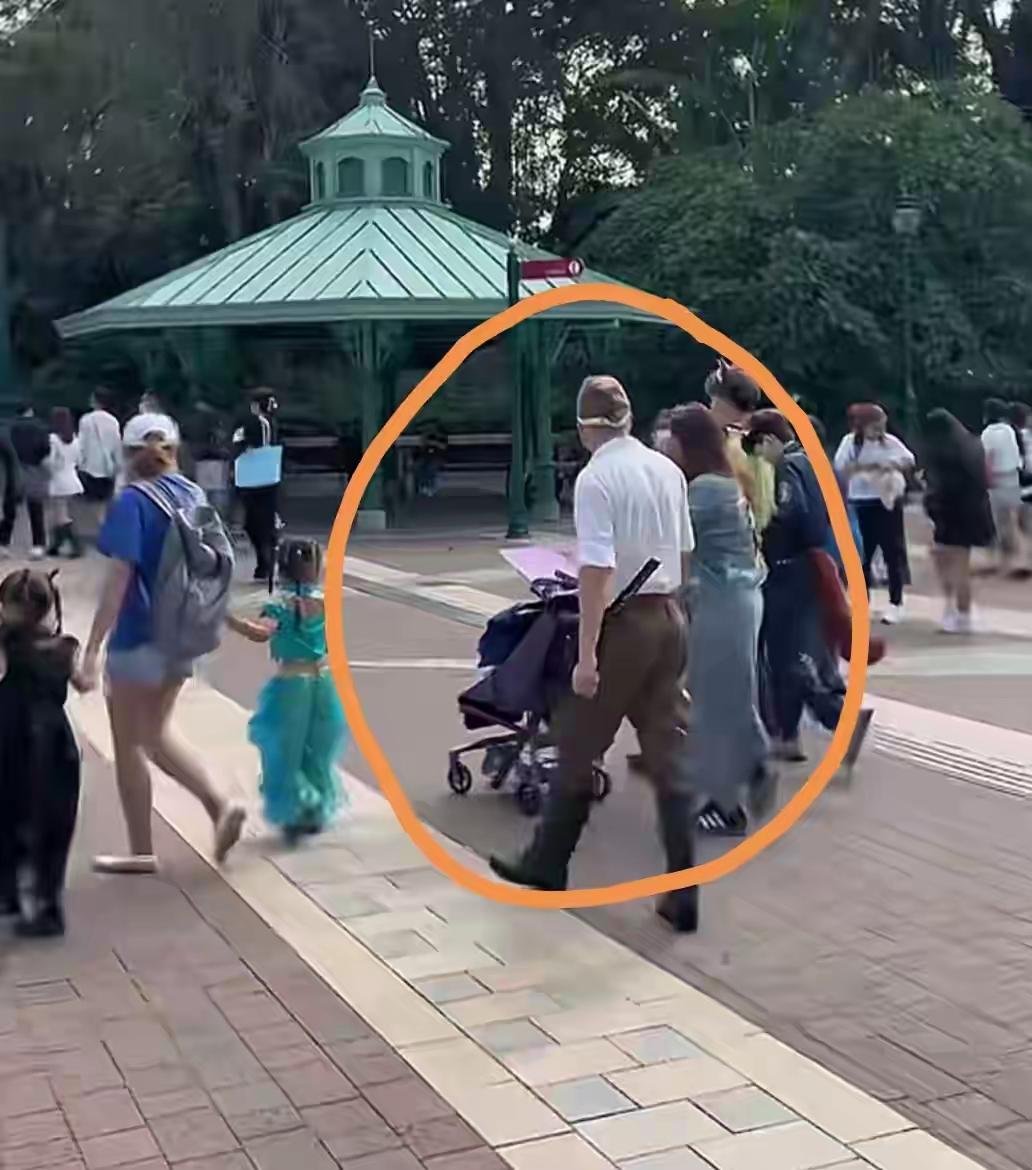 香港迪士尼的军服风波那个穿日军军服的男人带着家人有说有笑，在童话城堡前格外刺