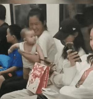 小宝宝把美女都看得害羞了，这也应了那句古话：食色性也。这么大的小孩天真无邪，他