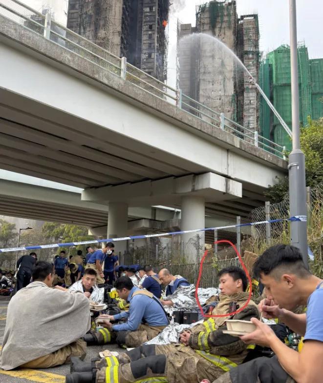 看到这张照片，真的让人瞬间心碎，起火的高楼还在冒黑烟，水枪的水还朝着火场浇