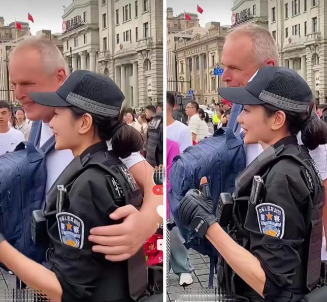 国庆外滩，一名老外想搭执勤女特警的肩膀合影，姑娘笑着手一拨："Sorry，执勤呢