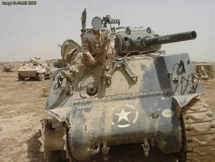 M4（105）“谢尔曼”，背景中有一辆M8“灰狗”装甲车，地点为伊拉克库克营，摄于2006年。这辆“