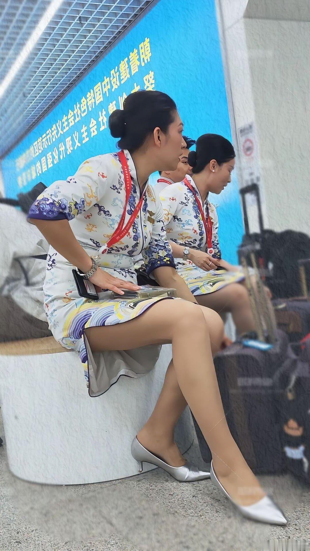 两位女士坐在长椅上等车。