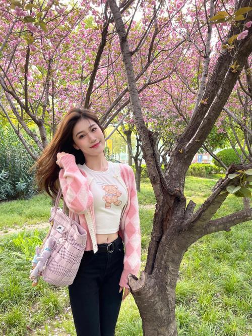 春日赏花，粉衣少女笑语如花映春光。粉裙花畔照粉裙穿搭