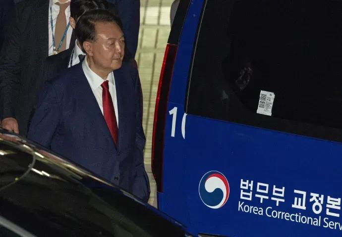 在特检组的强大压力审问下，尹锡悦终于低头认罪了，他被押上了警车，看上去非常地低沉