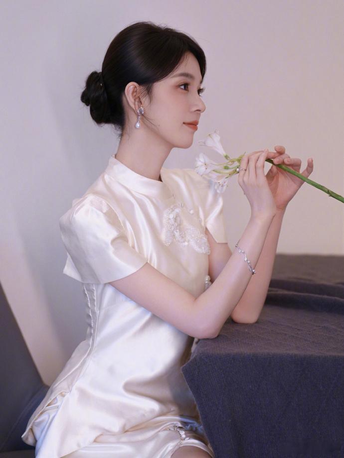 陈瑶素色旗袍拍出东方诗意一袭素色缎面旗袍衬得陈瑶温婉动人，竹枝纸灯笼布景氛围感浑