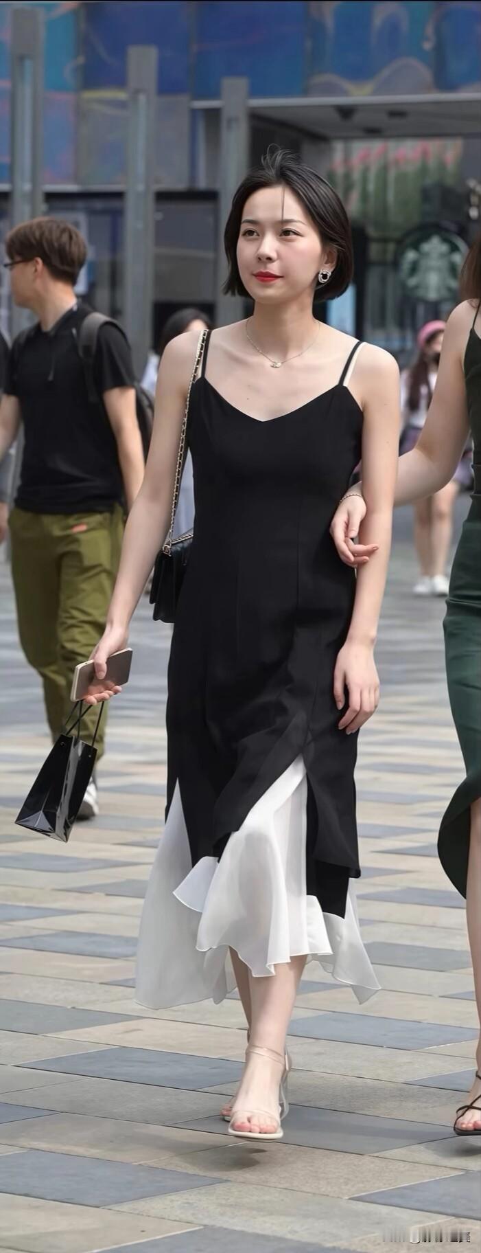 黑白色拼接吊带裙，裙摆的设计灵动又飘逸，简约配色也能穿出高级感～