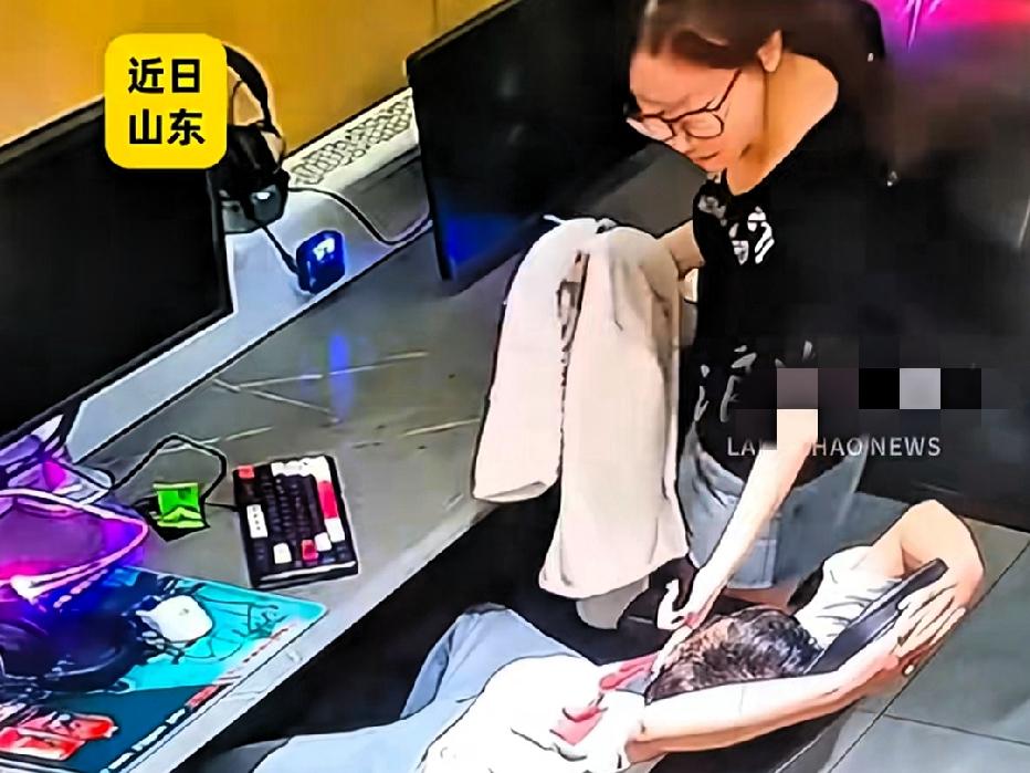 近日山东青岛，凌晨3点，一男子在网吧里睡着了，女服务员看到后过来给他盖被子，没想
