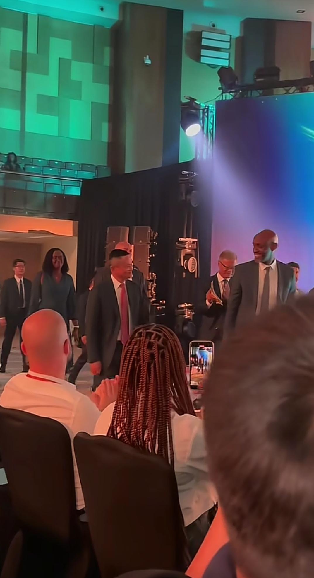 马云现身卢旺达，穿着一身黑色西装，搭配白色衬衫和红色领带，穿的这么正式是来参加会