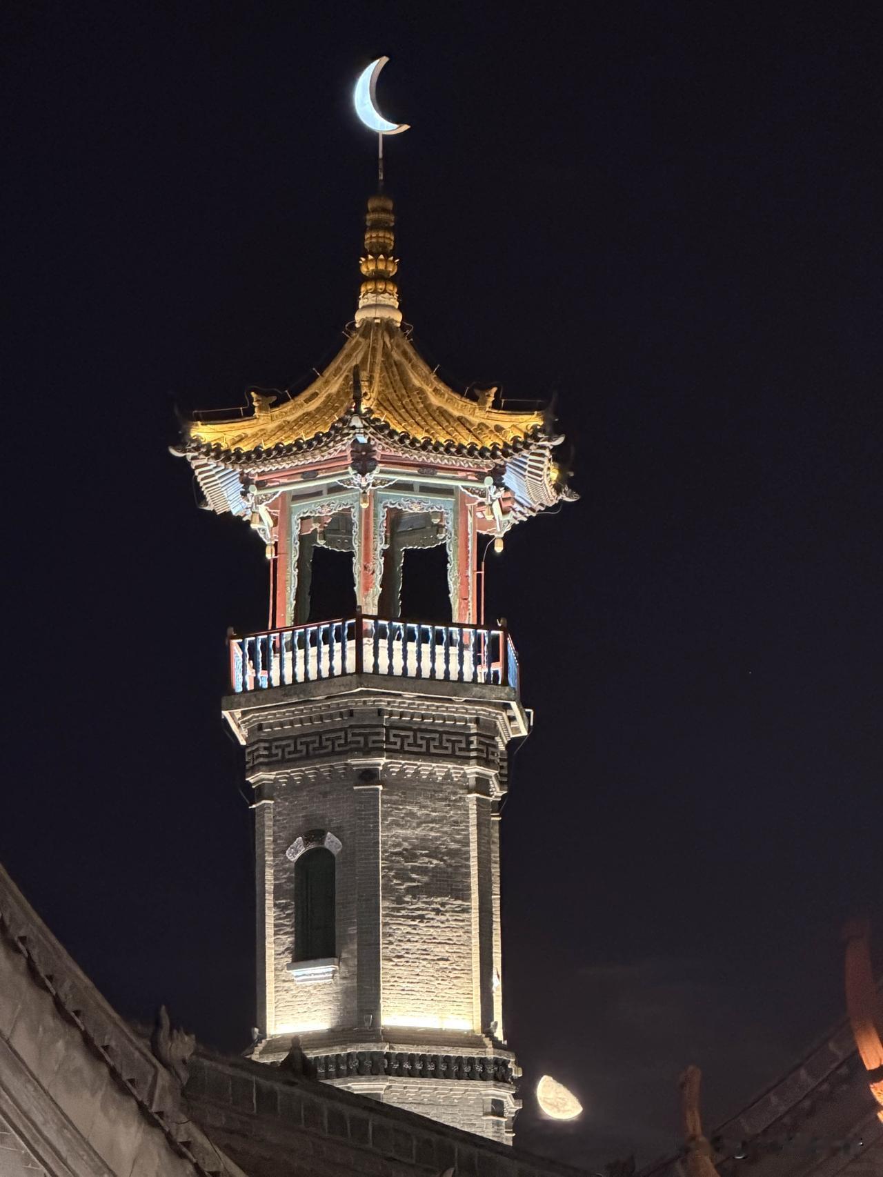 夜幕降临，呼和浩特大召古建筑灯火璀璨，鎏金飞檐在夜色里格外好看。一旁的宝尔汗佛塔