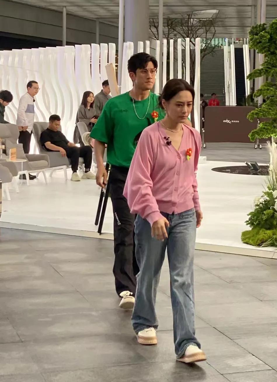 镜头中的钟欣潼纤秾合度，眉清目秀，云鬓花颜，莲步轻移，气质清绝；身后那位高大修伟