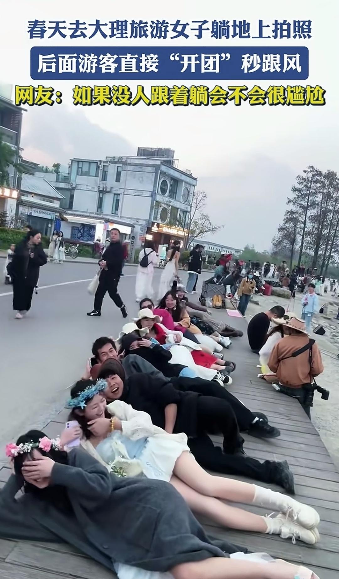 两位女游客在大理游玩时，触景生情，随性躺在地上拍照。这一幕勾起了其他游客的兴致，