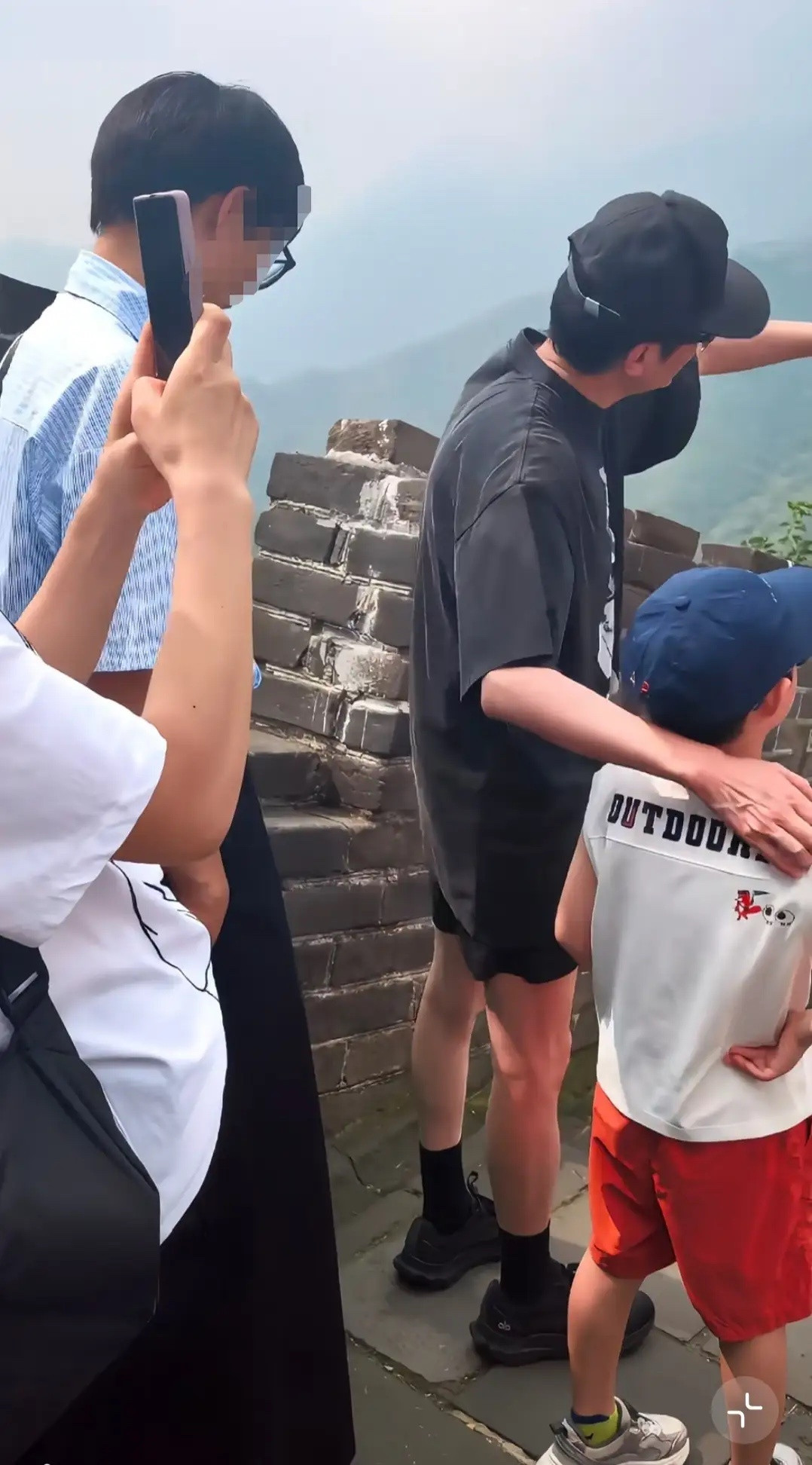 冯绍峰带与赵丽颖所生的儿子爬长城被偶遇冯绍峰从头到脚一身黑打扮，戴黑色帽子，穿黑