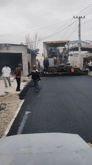 河南某地，村民抢夺修路材料填补自家门前的坑，被工作人员制止后仍无动于衷。工作