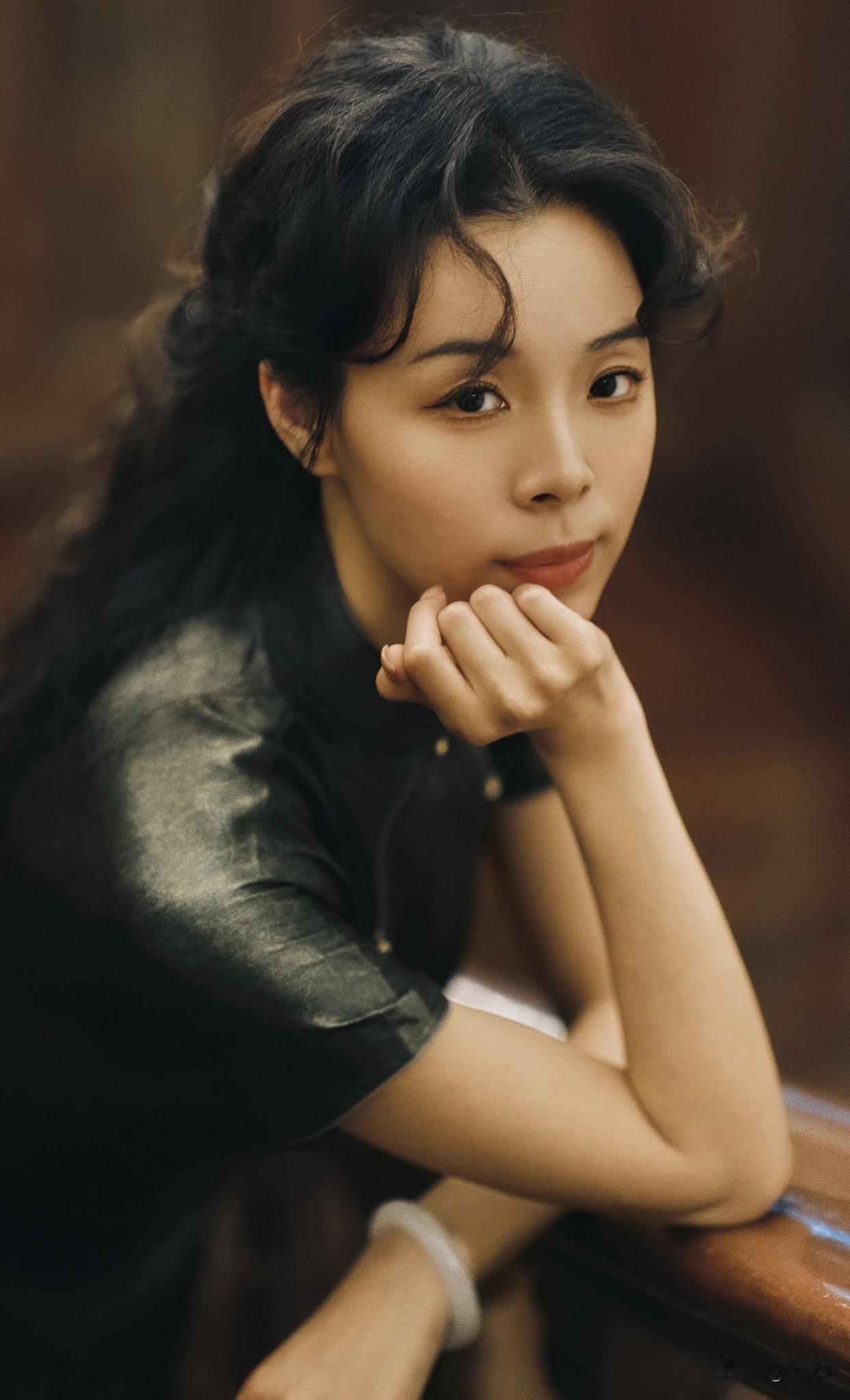 看《给阿嬷的情书》写时代回望复古风情的优雅女子，倚靠在雕花木门旁，沉思的姿态引人