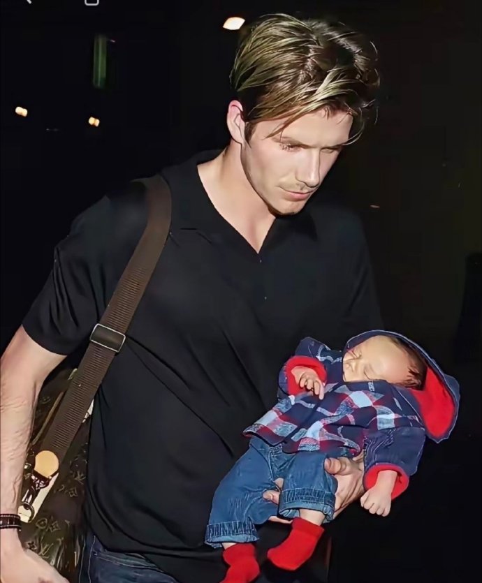 小贝夫妇臂力惊人，都是单手抱娃，看着轻松又时尚。这哪是在抱娃，更像是拎着一个时尚