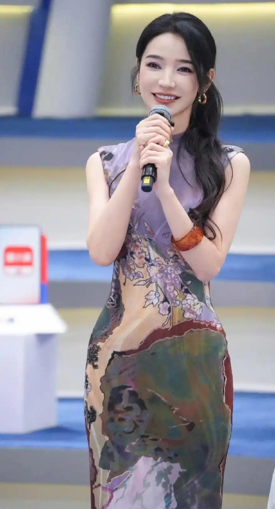 代斯，身穿紫色旗袍搭配长发，有韵味又有女人味，被她手上戴的大手镯吸引住了，好美啊