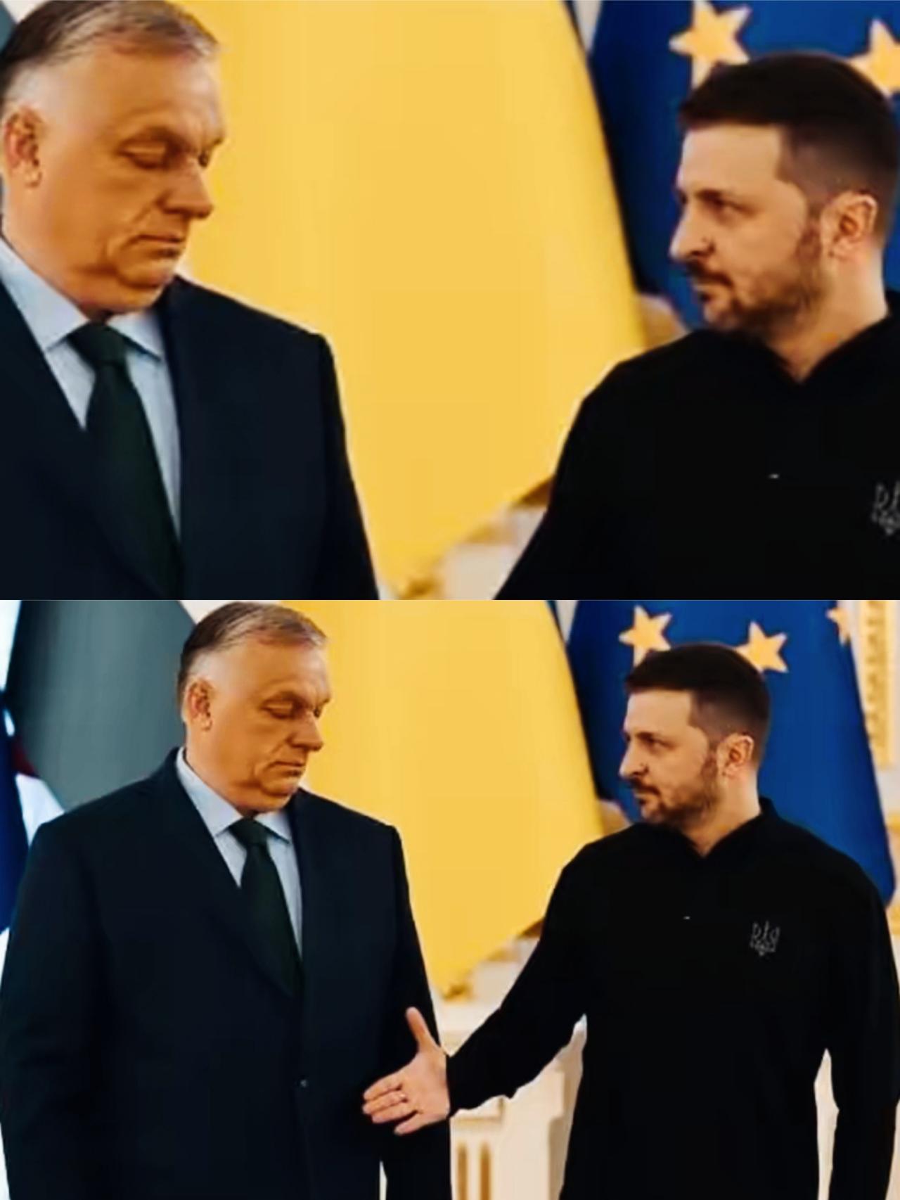 欧尔班面对泽连斯基伸过来的手，面部表情是什么意思呢？泽连斯基手都伸过来了，欧尔