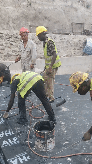 一个专门做屋顶防水的中国师父带着他的五个黑人学徒正在非洲某国的一个建筑工地干活。