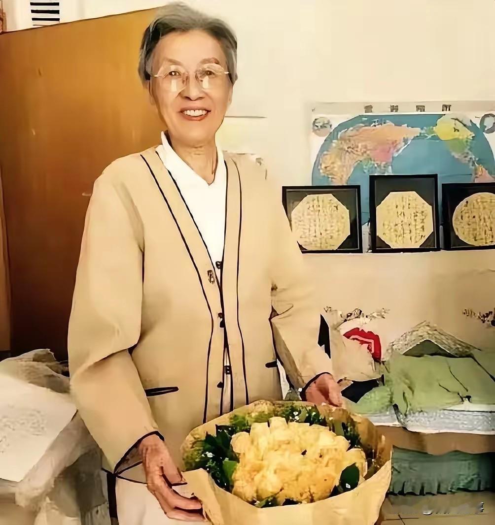 谢静宜晚年时期的留影，她身着一身浅米色外套，脸上带着温和慈祥的笑容，神态平和淡然