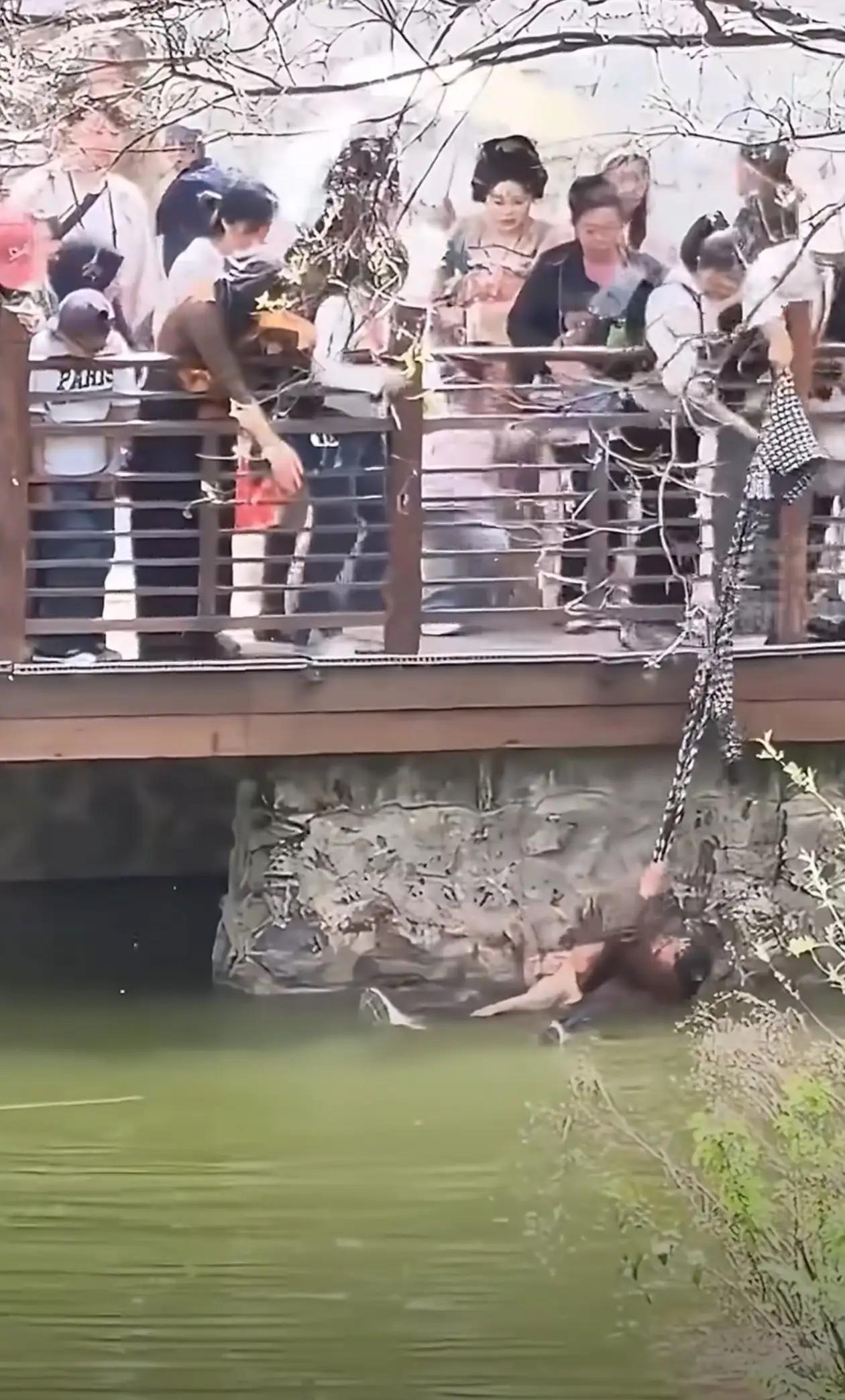 兴庆宫公园暖心一幕：白衣女子用外套当绳，勇救落水母子近日，陕西西安兴庆宫公