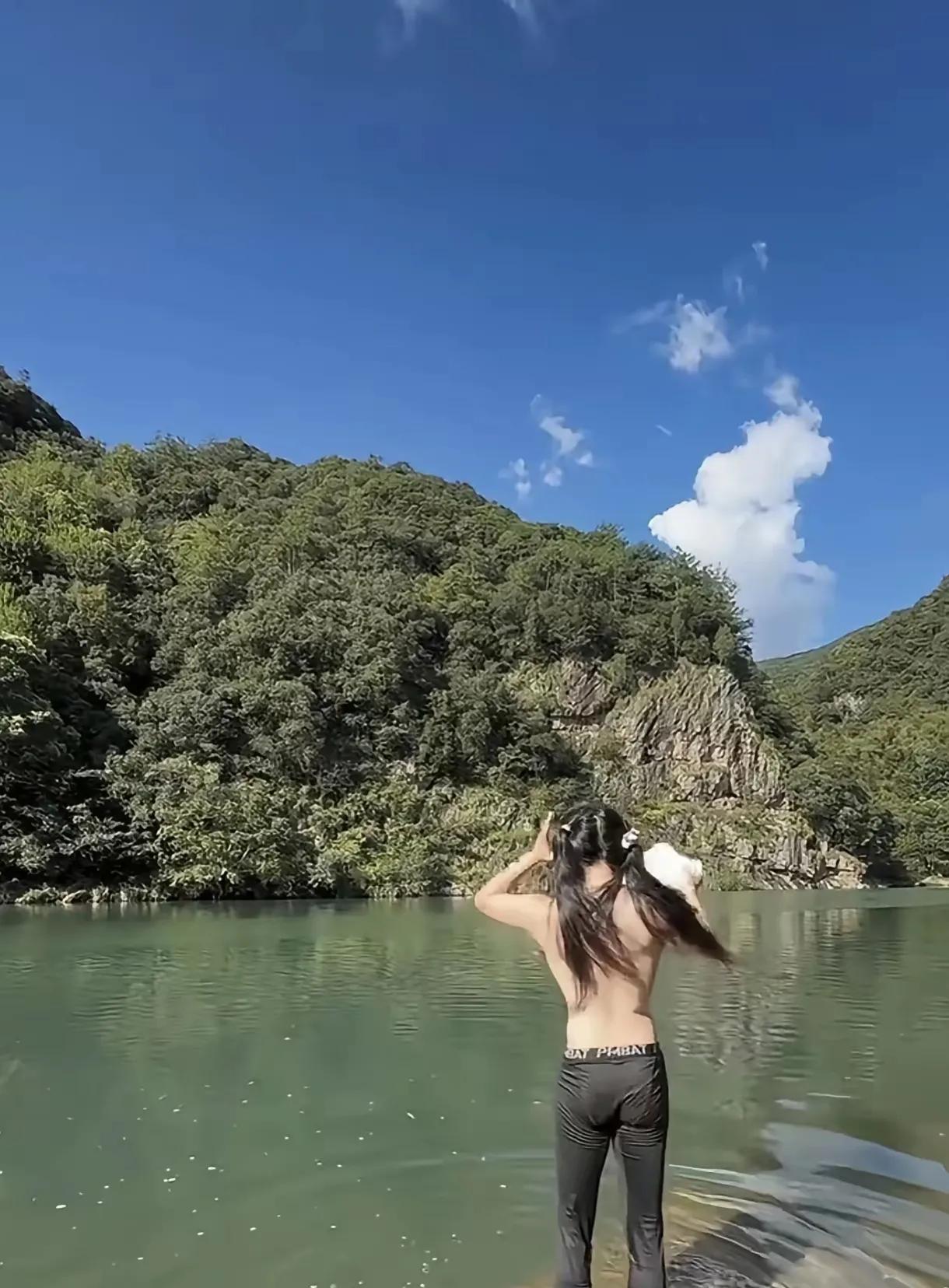 在河边看到一名身材姣好，长发飘飘的美女在河里洗澡，关键是她上身脱的赤条条，连胸罩