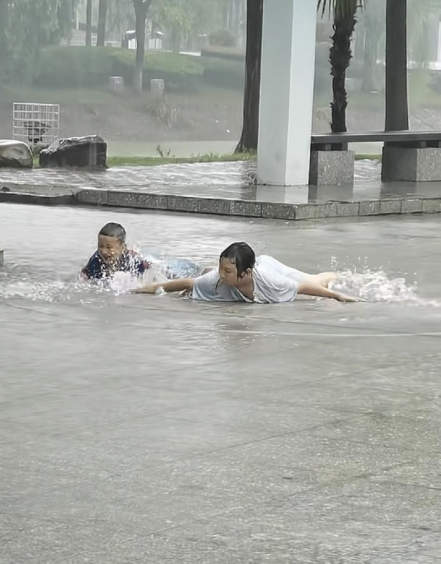 母子俩的童年这下完满了放学回家的路上下起了暴雨，接儿子回家的妈妈看到了这个情况