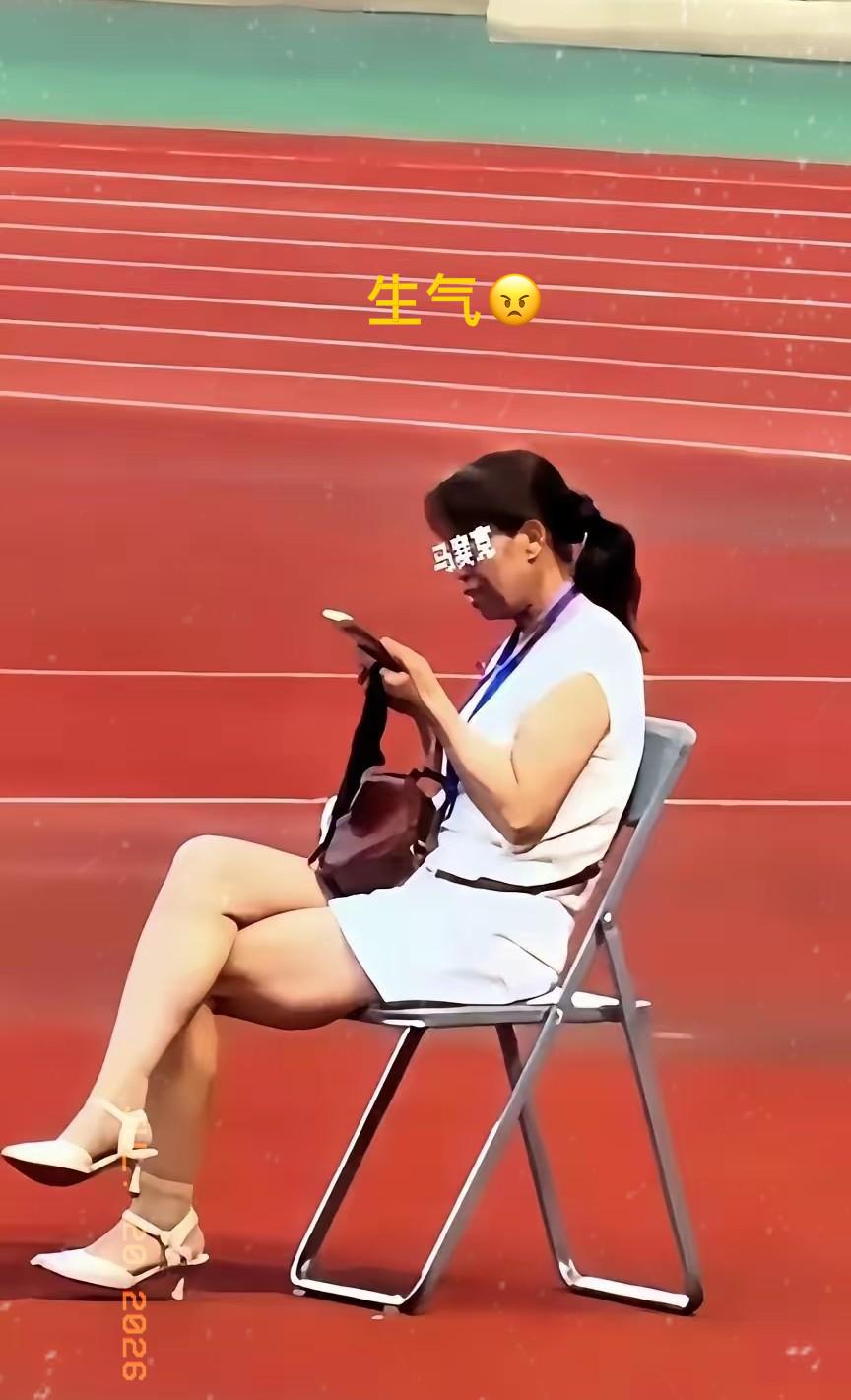 全网都在找这个甘肃陇超的女子是谁，她坐在一张椅子上，翘着二郎腿，刷着手机，脖子上