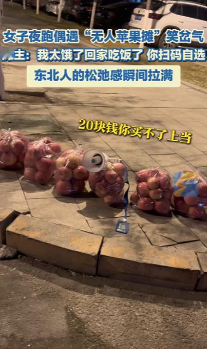 “笑不活了！”10月27日在辽宁鞍山，有位夜跑的女士发现了个有趣的摊位，几袋红苹