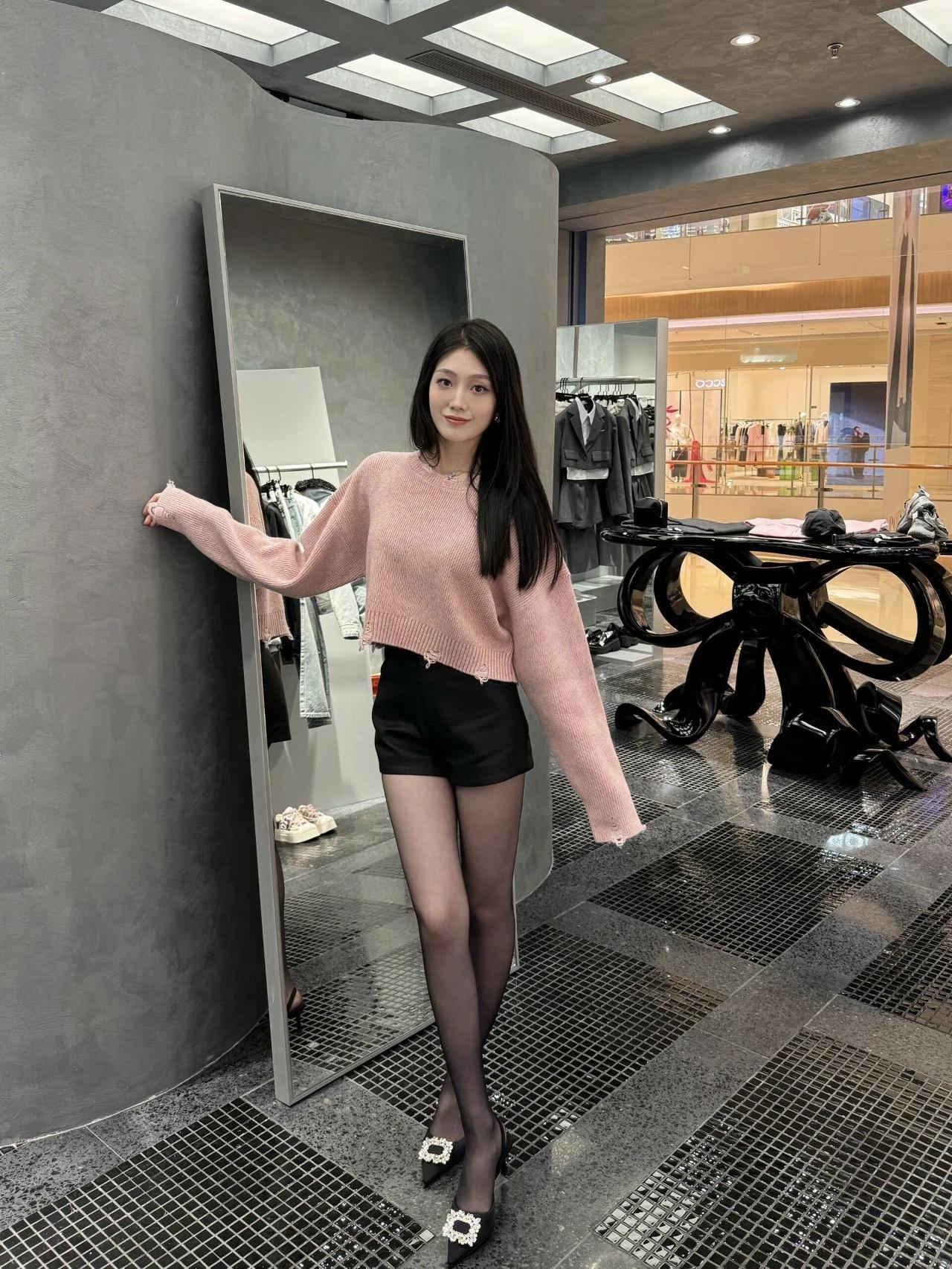 粉调软糯毛衣撞上利落黑短裤，甜妹的温柔与辣妹的飒爽一键拿捏，黑丝+钻扣高跟鞋添上