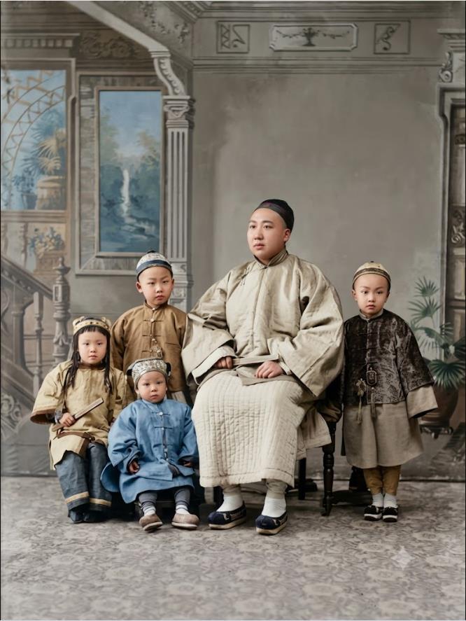 晚清，照相馆，一位士绅父亲与四位子女的合影。中心端坐的是家中男主人，头戴瓜皮小